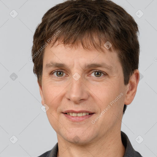 Joyful white adult male with short  brown hair and grey eyes