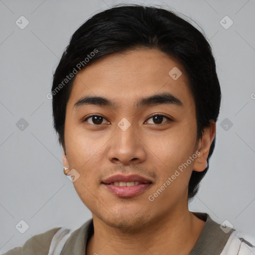 Joyful asian young-adult male with short  black hair and brown eyes