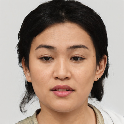 Joyful asian young-adult female with medium  black hair and brown eyes