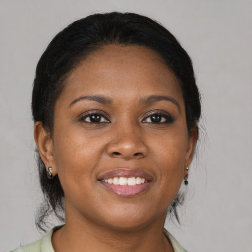 Joyful black young-adult female with medium  brown hair and brown eyes