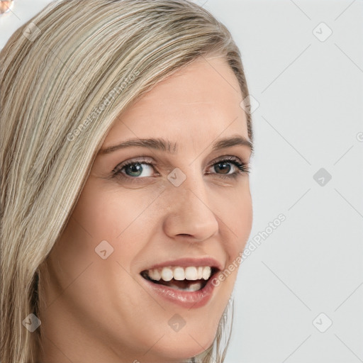 Joyful white young-adult female with long  brown hair and blue eyes