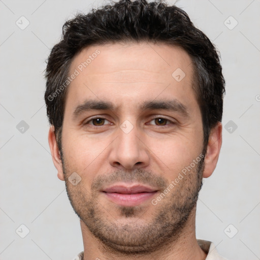 Joyful white young-adult male with short  black hair and brown eyes