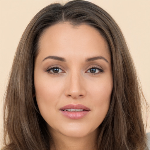 Joyful white young-adult female with long  brown hair and brown eyes