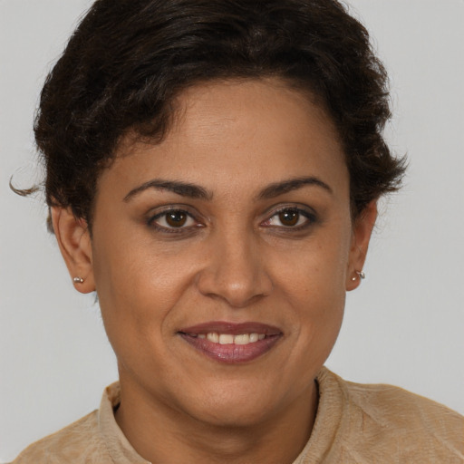 Joyful latino young-adult female with short  brown hair and brown eyes
