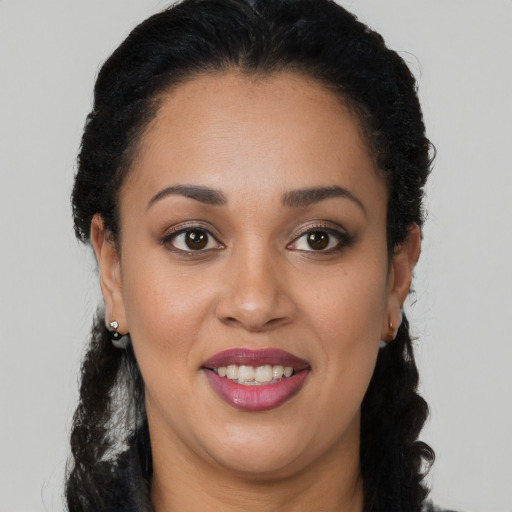 Joyful latino young-adult female with long  brown hair and brown eyes