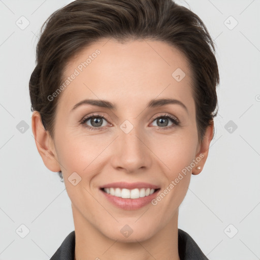 Joyful white young-adult female with short  brown hair and grey eyes