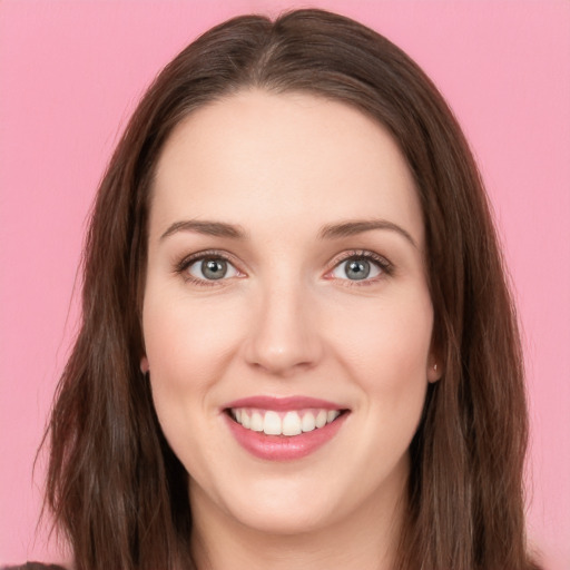 Joyful white young-adult female with long  brown hair and green eyes