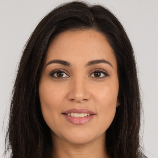 Joyful white young-adult female with long  brown hair and brown eyes