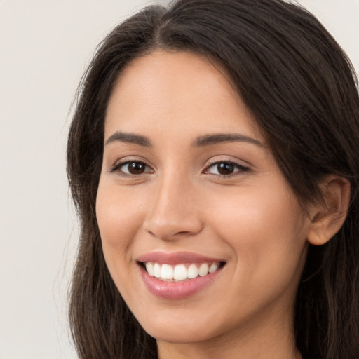 Joyful white young-adult female with long  brown hair and brown eyes