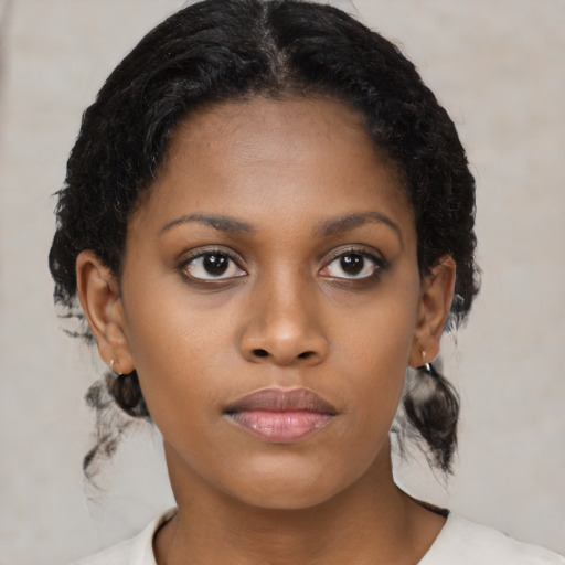 Neutral black young-adult female with medium  brown hair and brown eyes