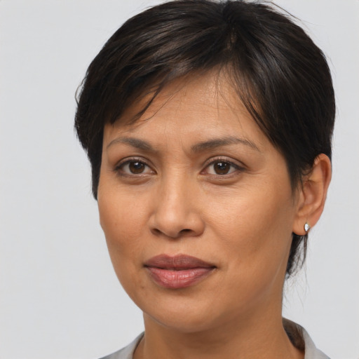 Joyful asian adult female with medium  brown hair and brown eyes
