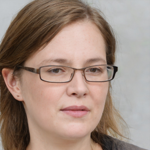 Joyful white adult female with medium  brown hair and blue eyes