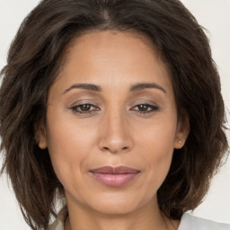 Joyful white adult female with long  brown hair and brown eyes