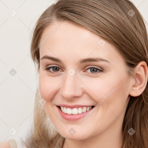 Joyful white young-adult female with long  brown hair and grey eyes