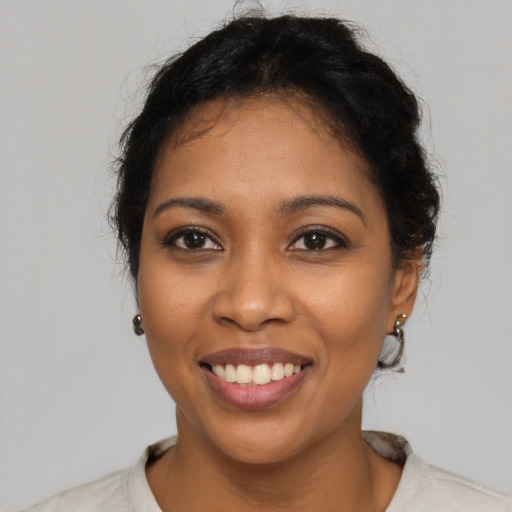 Joyful black young-adult female with medium  black hair and brown eyes