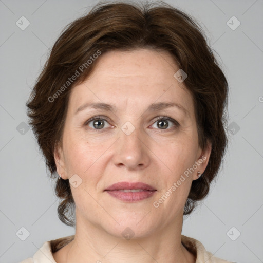 Joyful white adult female with medium  brown hair and grey eyes