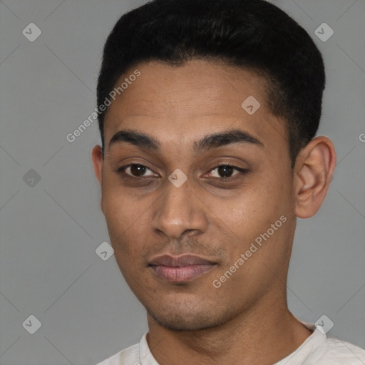 Joyful latino young-adult male with short  black hair and brown eyes