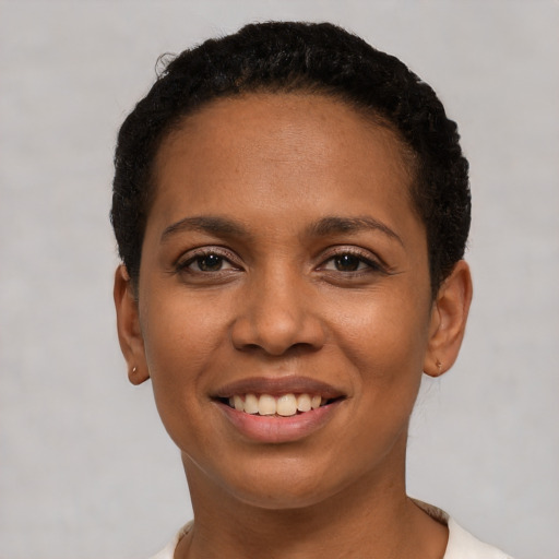 Joyful latino young-adult female with short  brown hair and brown eyes