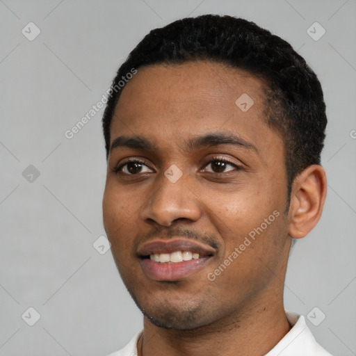 Joyful black young-adult male with short  black hair and brown eyes