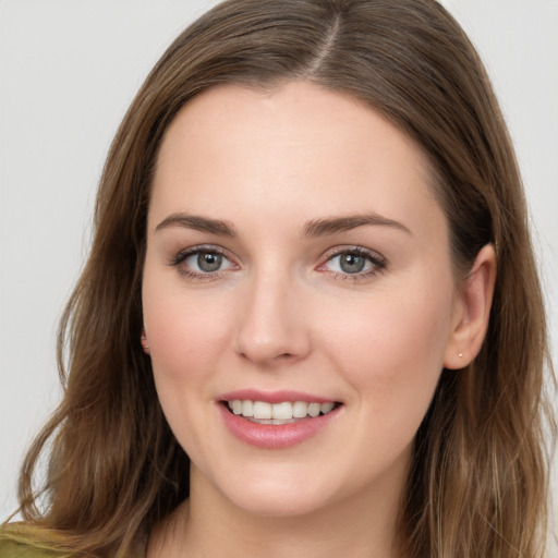 Joyful white young-adult female with long  brown hair and grey eyes