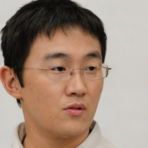 Neutral asian young-adult male with short  brown hair and brown eyes