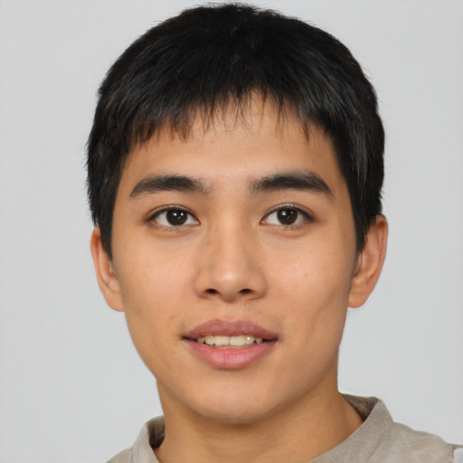 Joyful asian young-adult male with short  black hair and brown eyes