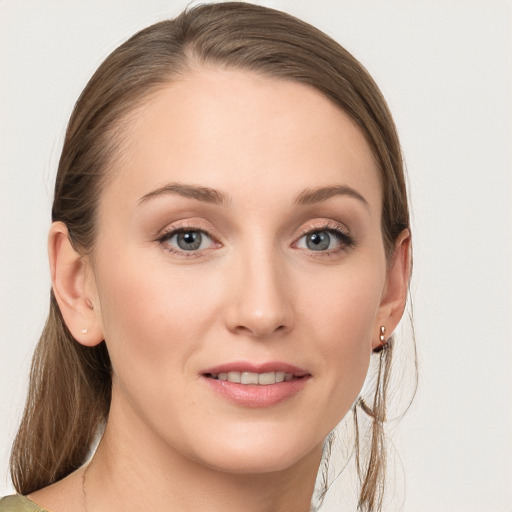 Joyful white young-adult female with long  brown hair and blue eyes