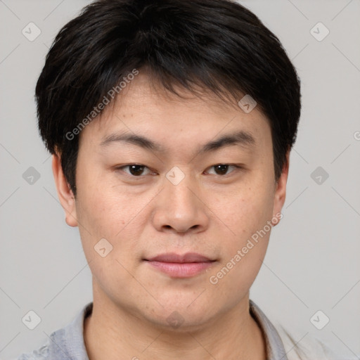 Joyful asian young-adult male with short  brown hair and brown eyes