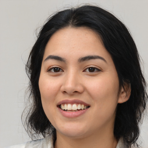 Joyful latino young-adult female with medium  black hair and brown eyes