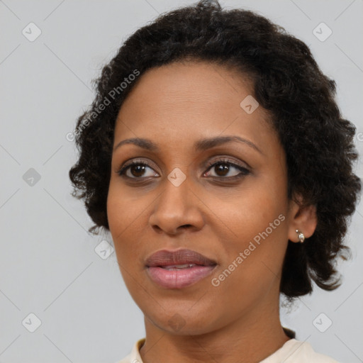 Joyful black adult female with short  brown hair and brown eyes