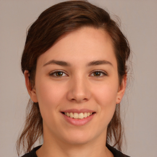 Joyful white young-adult female with medium  brown hair and brown eyes