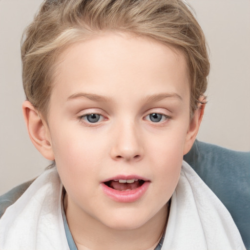 Joyful white child female with short  brown hair and blue eyes