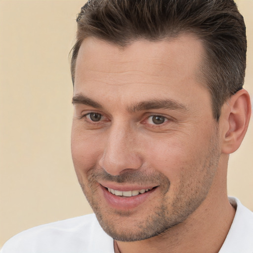 Joyful white adult male with short  brown hair and brown eyes