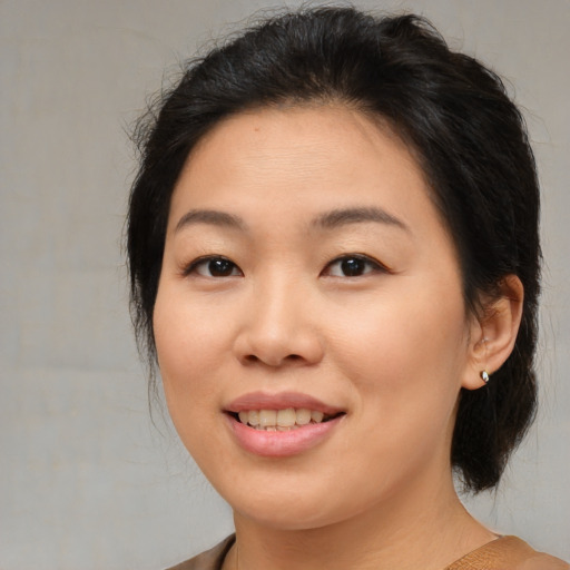 Joyful asian young-adult female with medium  brown hair and brown eyes