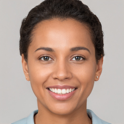 Joyful white young-adult female with short  brown hair and brown eyes