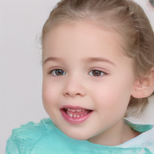 Joyful white child female with short  brown hair and blue eyes