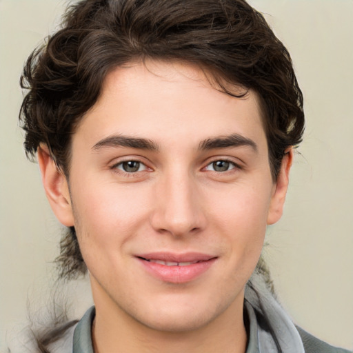 Joyful white young-adult male with medium  brown hair and brown eyes