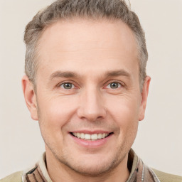 Joyful white adult male with short  brown hair and grey eyes