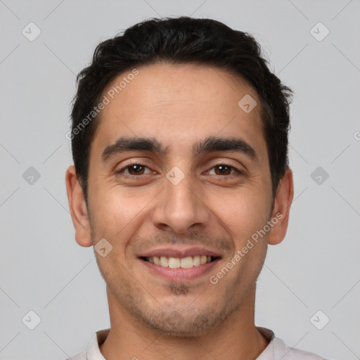 Joyful white young-adult male with short  black hair and brown eyes