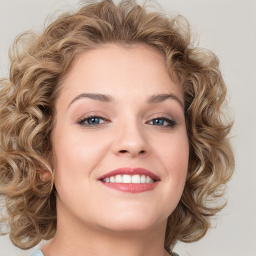 Joyful white young-adult female with medium  brown hair and green eyes