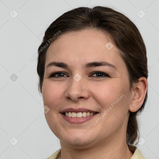 Joyful white young-adult female with medium  brown hair and brown eyes