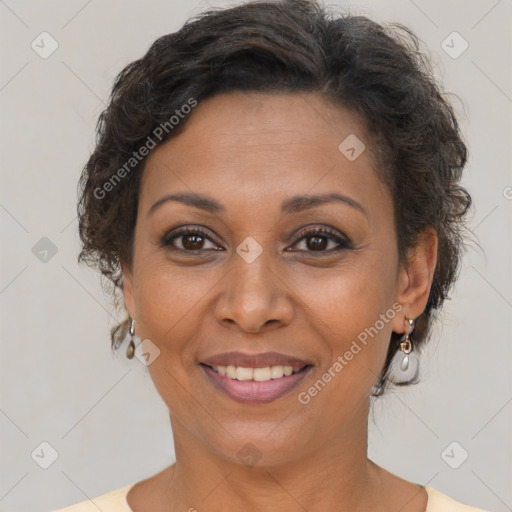 Joyful latino adult female with medium  brown hair and brown eyes