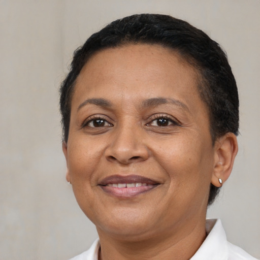 Joyful latino adult female with short  brown hair and brown eyes