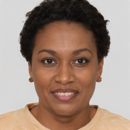 Joyful black young-adult female with short  brown hair and brown eyes