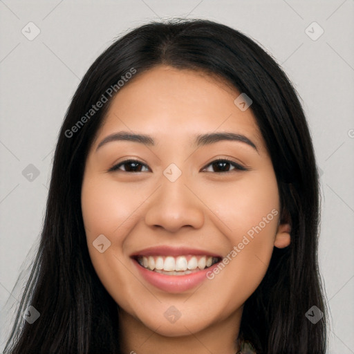 Joyful latino young-adult female with long  black hair and brown eyes