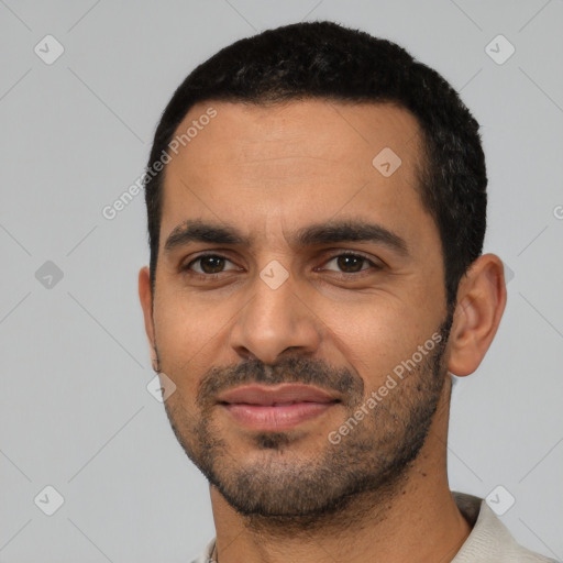 Joyful latino young-adult male with short  black hair and brown eyes