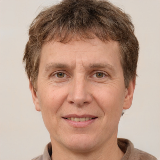 Joyful white adult male with short  brown hair and grey eyes