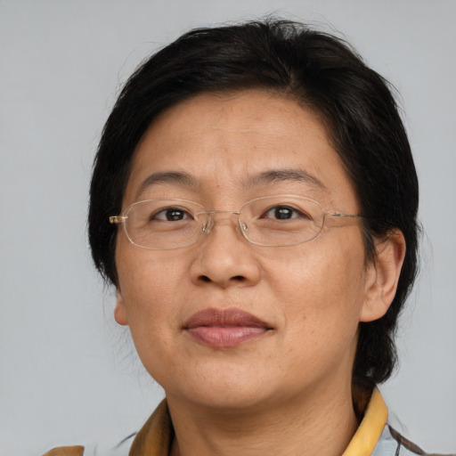 Joyful asian adult female with medium  brown hair and brown eyes