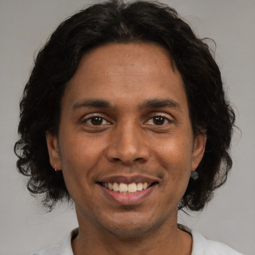 Joyful white adult male with medium  brown hair and brown eyes