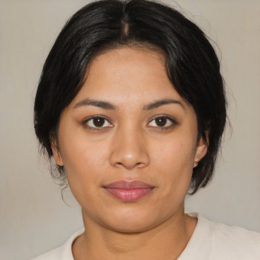 Joyful latino young-adult female with medium  black hair and brown eyes